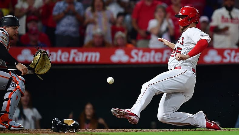 Aug 7, 2023; Anaheim, California, USA; Los Angeles Angels first baseman C.J. Cron scores a run against San Francisco Giants catcher Patrick Bailey (14) during the sixth inning at Angel Stadium. Mandatory Credit: Gary A. Vasquez-USA TODAY Sports