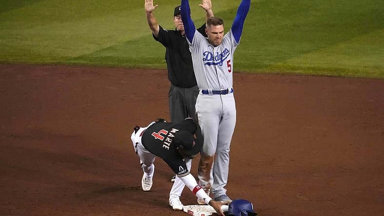 Aug 8, 2023; Phoenix, Arizona, USA; Los Angeles Dodgers first baseman Freddie Freeman (5) beats the tag of Arizona Diamondbacks second baseman Ketel Marte (4) for an RBI double during the fifth inning at Chase Field. Mandatory Credit: Joe Camporeale-USA TODAY Sports