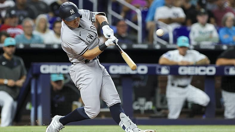 Aug 11, 2023; Miami, Florida, USA; New York Yankees shortstop Anthony Volpe (11) hits a three-run home run against the Miami Marlins during the second inning at loanDepot Park. Mandatory Credit: Sam Navarro-USA TODAY Sports