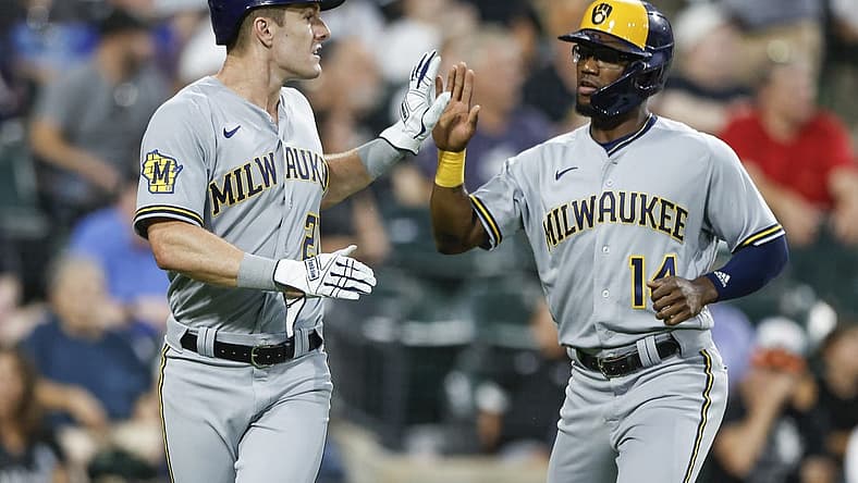 Aug 12, 2023; Chicago, Illinois, USA; Milwaukee Brewers second baseman Andruw Monasterio (14) celebrates with left fielder Mark Canha (21) after they both scored against the Chicago White Sox during the seventh inning at Guaranteed Rate Field. Mandatory Credit: Kamil Krzaczynski-USA TODAY Sports