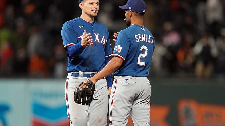 Aug 12, 2023; San Francisco, California, USA; Texas Rangers shortstop Corey Seager (left) celebrates with second baseman Marcus Semien (2) after defeating the San Francisco Giants at Oracle Park. Mandatory Credit: Darren Yamashita-USA TODAY Sports