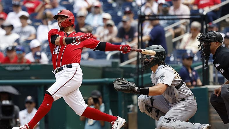 Aug 13, 2023; Washington, District of Columbia, USA; Washington Nationals shortstop Ildemaro Vargas (14) hits a single against the Oakland Athletics during the third inning at Nationals Park. Mandatory Credit: Geoff Burke-USA TODAY Sports