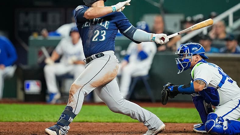 Aug 15, 2023; Kansas City, Missouri, USA; Seattle Mariners first baseman Ty France (23) hits a two-run single against the Kansas City Royals during the tenth inning at Kauffman Stadium. Mandatory Credit: Jay Biggerstaff-USA TODAY Sports