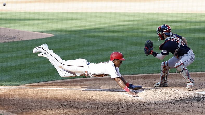 Aug 17, 2023; Washington, District of Columbia, USA; Washington Nationals second baseman Jeter Downs (3) scores a run ahead of a tag by Boston Red Sox catcher Connor Wong (12) on a two run double by Nationals designated hitter Joey Meneses (not pictured) during the fifth inning at Nationals Park. Mandatory Credit: Geoff Burke-USA TODAY Sports
