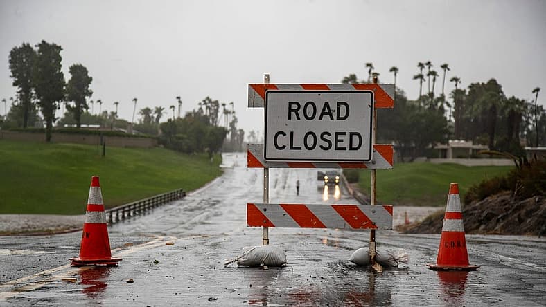 Country Club Drive is seen closed at the storm channel in Rancho Mirage, Calif., Sunday, Aug. 20, 2023.