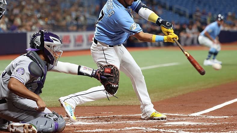 Aug 22, 2023; St. Petersburg, Florida, USA; Tampa Bay Rays third baseman Isaac Paredes (17) hits a sacrifice RBI against the Colorado Rockies during the first inning at Tropicana Field. Mandatory Credit: Kim Klement Neitzel-USA TODAY Sports