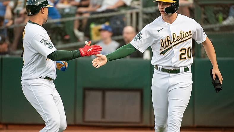Aug 22, 2023; Oakland, California, USA; Oakland Athletics second baseman Zack Gelof (20) celebrates with shortstop Aledmys Diaz (12) after scoring during the first inning against the Kansas City Royals at Oakland-Alameda County Coliseum. Mandatory Credit: Ed Szczepanski-USA TODAY Sports