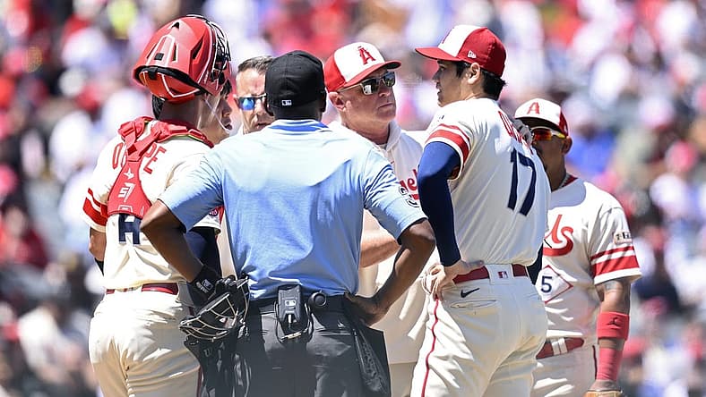Aug 23, 2023; Anaheim, California, USA; Los Angeles Angels manager Phil Nevin (center) meets with starting pitcher Shohei Ohtani (17) at the mound during the second inning against the Cincinnati Reds at Angel Stadium. Mandatory Credit: Orlando Ramirez-USA TODAY Sports