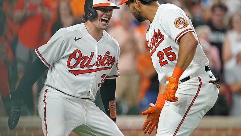 Aug 24, 2023; Baltimore, Maryland, USA; Baltimore Orioles outfielder Anthony Santander (25) greeted by catcher Adley Rutschman (35) following his two run home run in the fourth inning against the Toronto Blue Jays at Oriole Park at Camden Yards. Mandatory Credit: Mitch Stringer-USA TODAY Sports