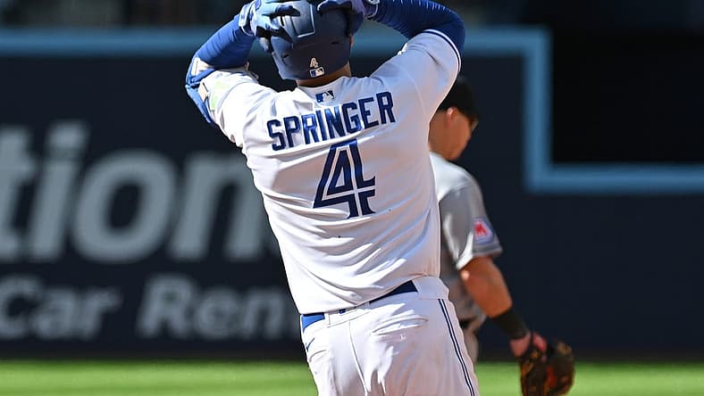 Aug 27, 2023; Toronto, Ontario, CAN; Toronto Blue Jays right fielder George Springer (4) reacts after his fly ball to the center field wall is caught by Cleveland Guardians center fielder Myles Straw (not pictured) in the eighth inning at Rogers Centre. Mandatory Credit: Dan Hamilton-USA TODAY Sports