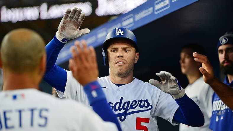 Aug 28, 2023; Los Angeles, California, USA; Los Angeles Dodgers first baseman Freddie Freeman (5) is greeted after hitting a solo home run against the Arizona Diamondbacks during the first inning at Dodger Stadium. Mandatory Credit: Gary A. Vasquez-USA TODAY Sports