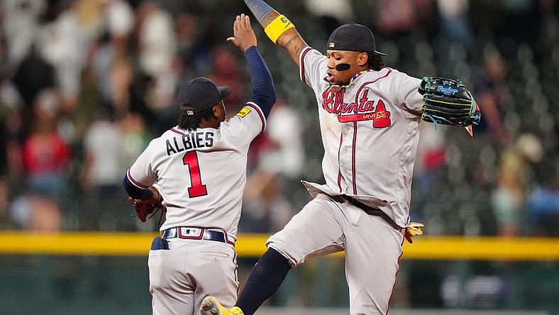 Aug 29, 2023; Denver, Colorado, USA; Atlanta Braves right fielder Ronald Acuna Jr. (13) and second baseman Ozzie Albies (1) celebrate defeating the Colorado Rockies at Coors Field. Mandatory Credit: Ron Chenoy-USA TODAY Sports