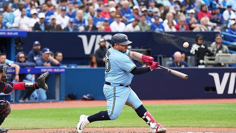 Aug 30, 2023; Toronto, Ontario, CAN; Toronto Blue Jays catcher Alejandro Kirk (30) hits an RBI sacrifice fly ball against the Washington Nationals during the seventh inning at Rogers Centre. Mandatory Credit: Nick Turchiaro-USA TODAY Sports