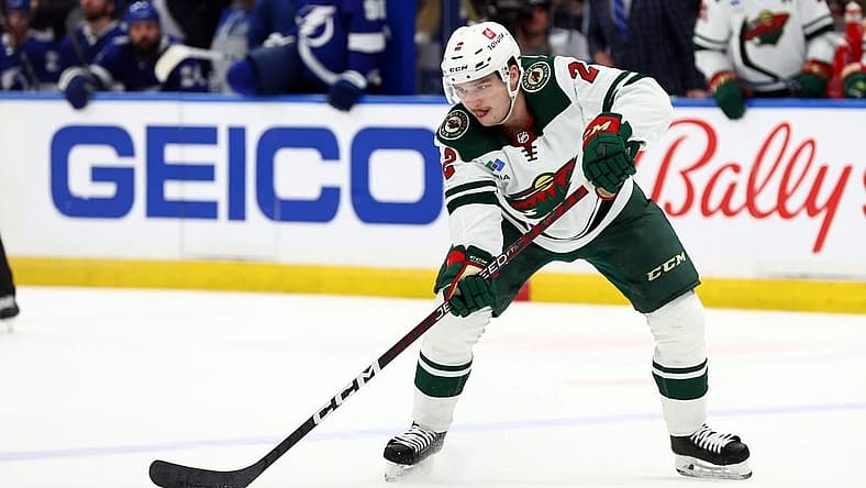 Jan 24, 2023; Tampa, Florida, USA; Minnesota Wild defenseman Calen Addison (2) passes the puck against the Tampa Bay Lightning during the second period at Amalie Arena. Mandatory Credit: Kim Klement-USA TODAY Sports