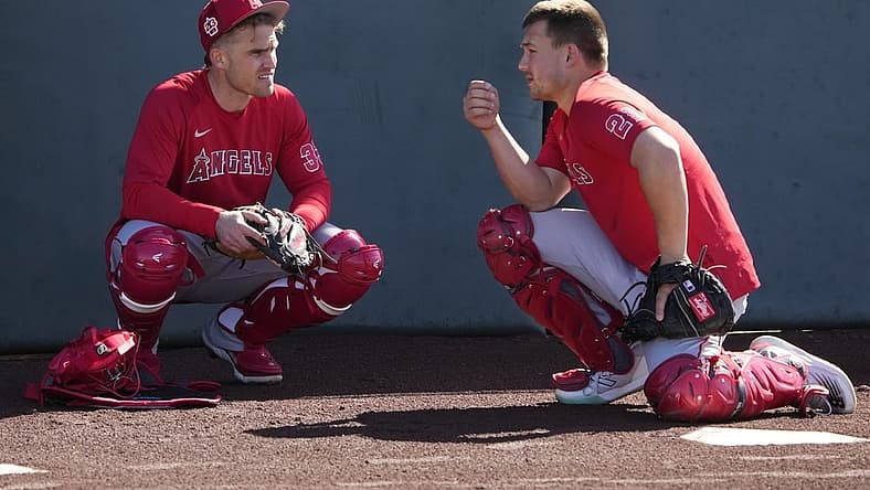 Feb 15, 2023; Tempe, AZ, USA; Los Angeles Angels catchers' Max Stassi (33) and Matt Thaiss (21) talk during spring training camp. Mandatory Credit: Rick Scuteri-USA TODAY Sports
