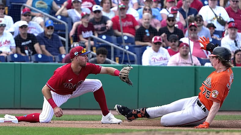 Mar 9, 2023; Clearwater, Florida, USA; Baltimore Orioles outfielder Heston Kjerstad (75) slides safely into third as Philadelphia Phillies third baseman Alec Bohm (28) waits for the ball during the seventh at BayCare Ballpark. Mandatory Credit: Dave Nelson-USA TODAY Sports