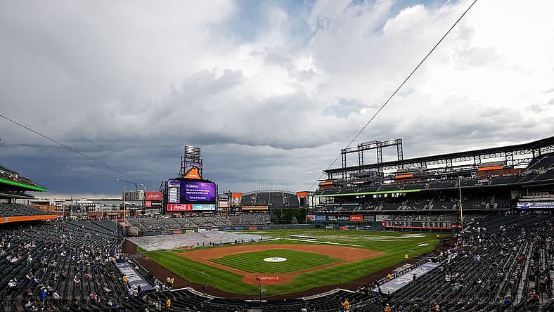 Jun 29, 2023; Denver, Colorado, USA; Grounds crew clear the infield tarp during a rain delay before the game between the Colorado Rockies and the Los Angeles Dodgers at Coors Field. Mandatory Credit: Isaiah J. Downing-USA TODAY Sports