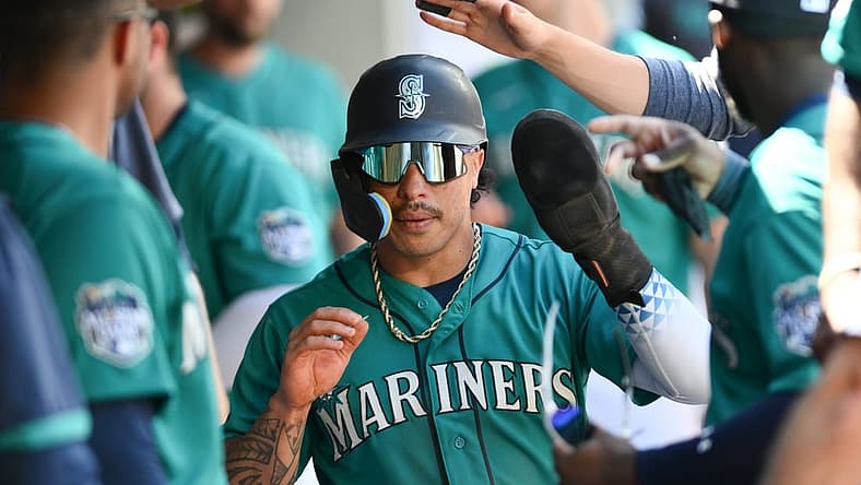 Jul 22, 2023; Seattle, Washington, USA; Seattle Mariners second baseman Kolten Wong (16) celebrates scoring a run against the Toronto Blue Jays in the seventh inning at T-Mobile Park. Mandatory Credit: Steven Bisig-USA TODAY Sports