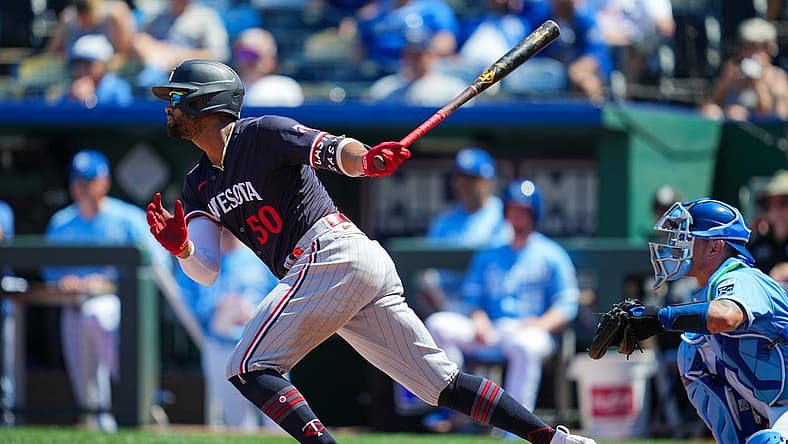 Jul 30, 2023; Kansas City, Missouri, USA; Minnesota Twins left fielder Willi Castro (50) hits a single against the Kansas City Royals during the seventh inning at Kauffman Stadium. Mandatory Credit: Jay Biggerstaff-USA TODAY Sports