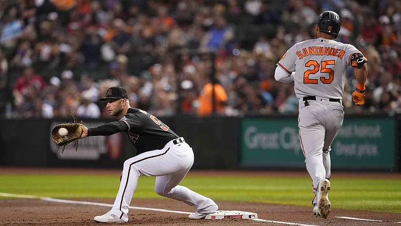 Sep 1, 2023; Phoenix, Arizona, USA; Arizona Diamondbacks first baseman Christian Walker (53) fields a throw to force out Baltimore Orioles right fielder Anthony Santander (25) during the first inning at Chase Field. Mandatory Credit: Joe Camporeale-USA TODAY Sports