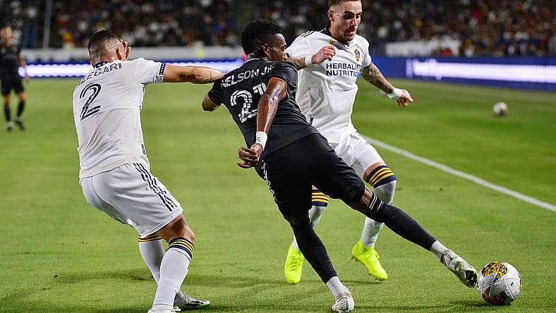 Sep 2, 2023; Carson, California, USA; Houston Dynamo forward Nelson Quinones (21) moves the ball against Los Angeles Galaxy defender Lucas Calegari (2) and midfielder Tyler Boyd (11) during the first half at Dignity Health Sports Park. Mandatory Credit: Gary A. Vasquez-USA TODAY Sports