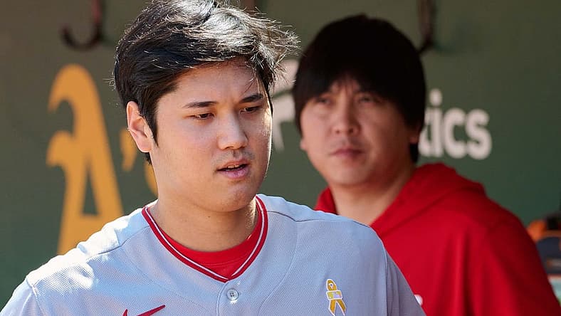 Sep 3, 2023; Oakland, California, USA; Los Angeles Angels designated hitter Shohei Ohtani (17) and interpreter Ippei Mizuhara stand in the dugout before the game between the Los Angeles Angels and the Oakland Athletics at Oakland-Alameda County Coliseum. Mandatory Credit: Robert Edwards-USA TODAY Sports