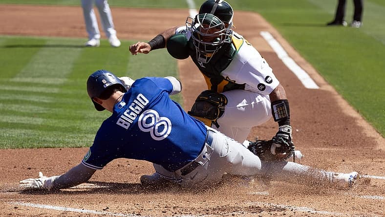 Sep 6, 2023; Oakland, California, USA; Toronto Blue Jays right fielder Cavan Biggio (8) scores a run against Oakland Athletics catcher Carlos P rez (44) during the second inning at Oakland-Alameda County Coliseum. Mandatory Credit: D. Ross Cameron-USA TODAY Sports