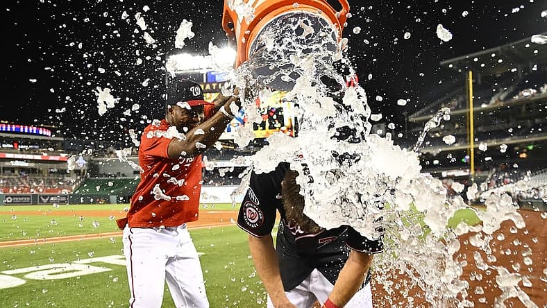 Sep 6, 2023; Washington, District of Columbia, USA; Washington Nationals outfielder Jacob Young (30) is doused with water by Washington Nationals outfielder Victor Robles (16) after hitting a walk off RBI single against the New York Mets during the ninth inning at Nationals Park. Mandatory Credit: Brad Mills-USA TODAY Sports