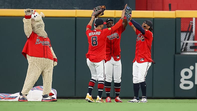 Sep 8, 2023; Atlanta, Georgia, USA; Atlanta Braves mascot Blooper and left fielder Eddie Rosario (8) and center fielder Michael Harris II (23) and right fielder Ronald Acuna Jr. (13) celebrate after a victory against the Pittsburgh Pirates at Truist Park. Mandatory Credit: Brett Davis-USA TODAY Sports