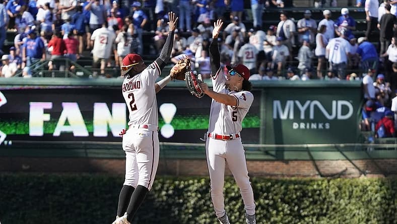 Sep 9, 2023; Chicago, Illinois, USA; Arizona Diamondbacks second baseman Geraldo Perdomo (2) and outfielder Alek Thomas (5) celebrate their win against the Chicago Cubs at Wrigley Field. Mandatory Credit: David Banks-USA TODAY Sports