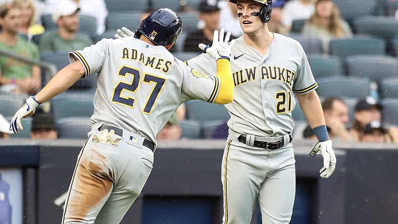 Sep 9, 2023; Bronx, New York, USA; Milwaukee Brewers shortstop Willy Adames (27) is greeted by right fielder Mark Canha (21) after hitting an RBI triple and scoring on an error in the fourth inning against the New York Yankees at Yankee Stadium. Mandatory Credit: Wendell Cruz-USA TODAY Sports