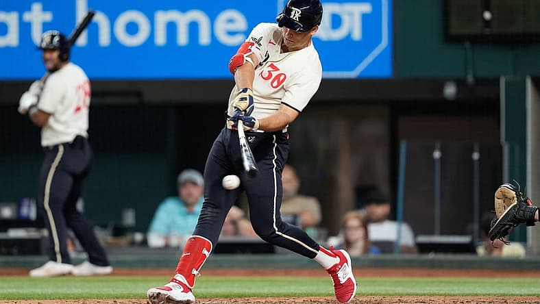 Sep 9, 2023; Arlington, Texas, USA; Texas Rangers first baseman Nathaniel Lowe (30) hits an RBI single against the Oakland Athletics during the sixth inning at Globe Life Field. Mandatory Credit: Jim Cowsert-USA TODAY Sports