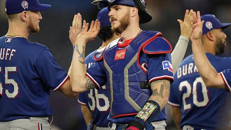 Sep 11, 2023; Toronto, Ontario, CAN; Texas Rangers catcher Jonah Heim (28) gets congratulated after a win over the Toronto Blue Jays at Rogers Centre. Mandatory Credit: John E. Sokolowski-USA TODAY Sports