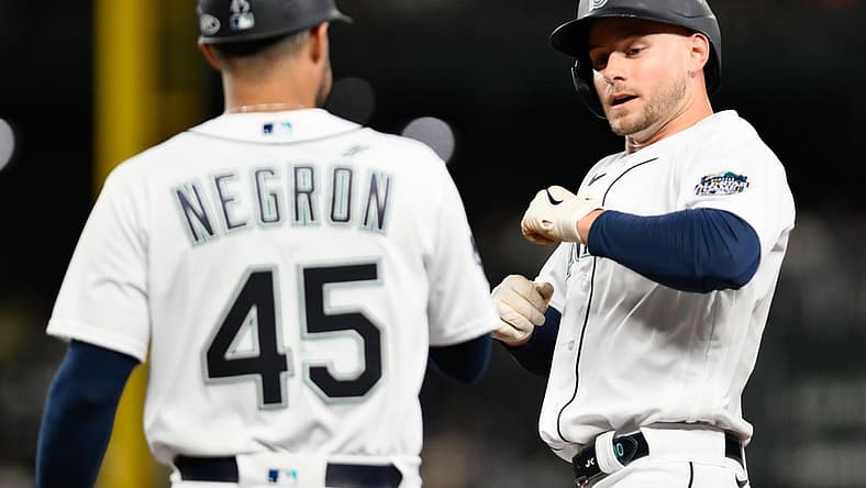 Sep 11, 2023; Seattle, Washington, USA; Seattle Mariners right fielder Jarred Kelenic (10) celebrates with first base coach Kristopher Negr  n (45) after hitting a single against the Los Angeles Angels during the fifth inning at T-Mobile Park. Mandatory Credit: Steven Bisig-USA TODAY Sports