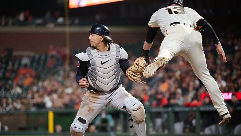 Sep 11, 2023; San Francisco, California, USA; San Francisco Giants outfielder Austin Slater (13) leaps after being tagged out by Cleveland Guardians catcher Bo Naylor (23) on a force play at home plate during the seventh inning at Oracle Park. Mandatory Credit: Robert Edwards-USA TODAY Sports