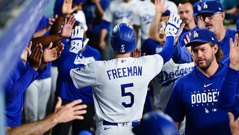 Sep 12, 2023; Los Angeles, California, USA; Los Angeles Dodgers first baseman Freddie Freeman (5) is greeted after hitting a two run home run against the San Diego Padres during the third inning at Dodger Stadium. Mandatory Credit: Gary A. Vasquez-USA TODAY Sports