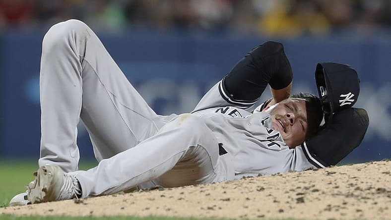 Sep 15, 2023; Pittsburgh, Pennsylvania, USA; New York Yankees relief pitcher Anthony Misiewicz (54) reacts after being hit in the head by a line drive off the bat of Pittsburgh Pirates second baseman Ji Hwan Bae (not pictured) during the sixth inning at PNC Park. Misiewicz would leave the game.Mandatory Credit: Charles LeClaire-USA TODAY Sports