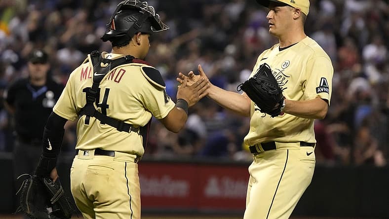 Sep 15, 2023; Phoenix, Arizona, USA; Arizona Diamondbacks catcher Gabriel Moreno (14) and pitcher Paul Sewald (38) celebrate after defeating the Chicago Cubs at Chase Field. Mandatory Credit: Rick Scuteri-USA TODAY Sports