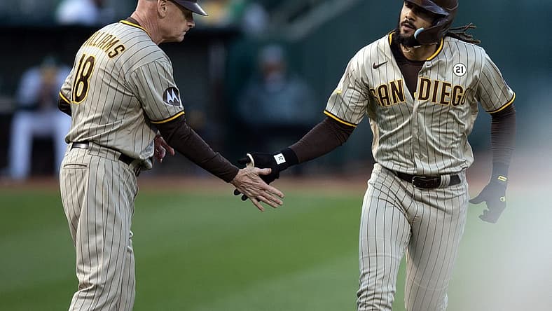 Sep 15, 2023; Oakland, California, USA; San Diego Padres right fielder Fernando Tatis Jr. (right) gets a congratulatory handshake from third base coach Matt Williams (18) after hitting a solo home run against the Oakland Athletics during the first inning at Oakland-Alameda County Coliseum. Mandatory Credit: D. Ross Cameron-USA TODAY Sports