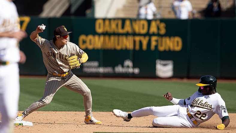 Sep 16, 2023; Oakland, California, USA; San Diego Padres second baseman Ha-Seong Kim (7) throws over Oakland Athletics center fielder Lawrence Butler (22) to complete a double play during the sixth inning at Oakland-Alameda County Coliseum. Mandatory Credit: D. Ross Cameron-USA TODAY Sports