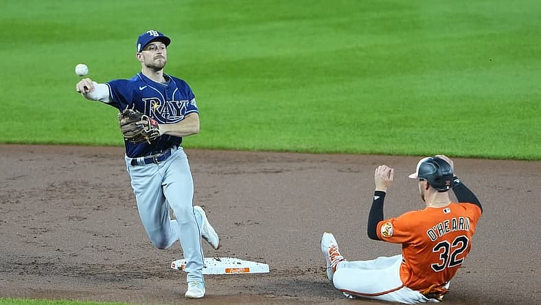Sep 16, 2023; Baltimore, Maryland, USA;  Tampa Bay Rays second baseman Brandon Lowe (8) turns a double play with Baltimore Orioles first baseman Ryan O'Hearn (32) sliding into second base during the first inning at Oriole Park at Camden Yards. Mandatory Credit: Gregory Fisher-USA TODAY Sports