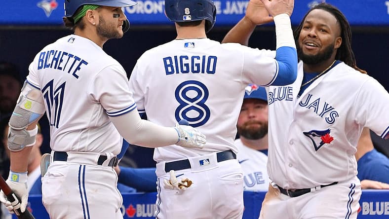 Sep 16, 2023; Toronto, Ontario, CAN; Toronto Blue Jays pinch runner Cavan Biggio (8) celebrates with shortstop Bo Bichette (11) and first baseman Vladimir Guerrero Jr. (27) after scoring against the Boston Red Sox in the ninth inning at Rogers Centre. Mandatory Credit: Dan Hamilton-USA TODAY Sports