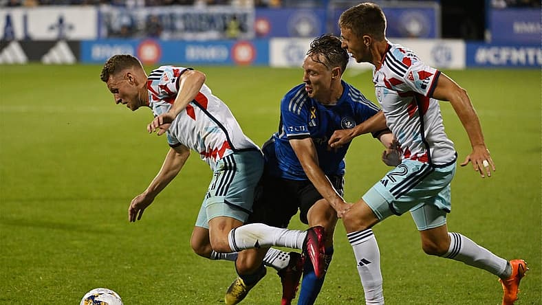 Sep 16, 2023; Montreal, Quebec, CAN; Chicago Fire forward Fabian Herbers (21) is tackled by CF Montreal midfielder Lassi Lappalainen (21) in the first half at Stade Saputo. Mandatory Credit: David Kirouac-USA TODAY Sports