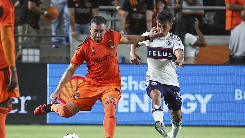Sep 20, 2023; Houston, Texas, USA; Houston Dynamo FC midfielder Hector Herrera (16) kicks the ball as Vancouver Whitecaps FC midfielder Andres Cubas (20) defends during the first half at Shell Energy Stadium. Mandatory Credit: Troy Taormina-USA TODAY Sports