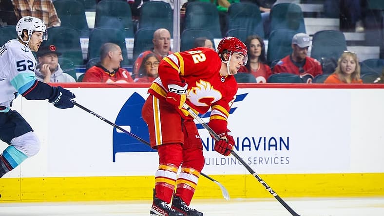 Sep 25, 2023; Calgary, Alberta, CAN; Calgary Flames left wing Jakob Pelletier (22) controls the puck against the Seattle Kraken during the first period at Scotiabank Saddledome. Mandatory Credit: Sergei Belski-USA TODAY Sports