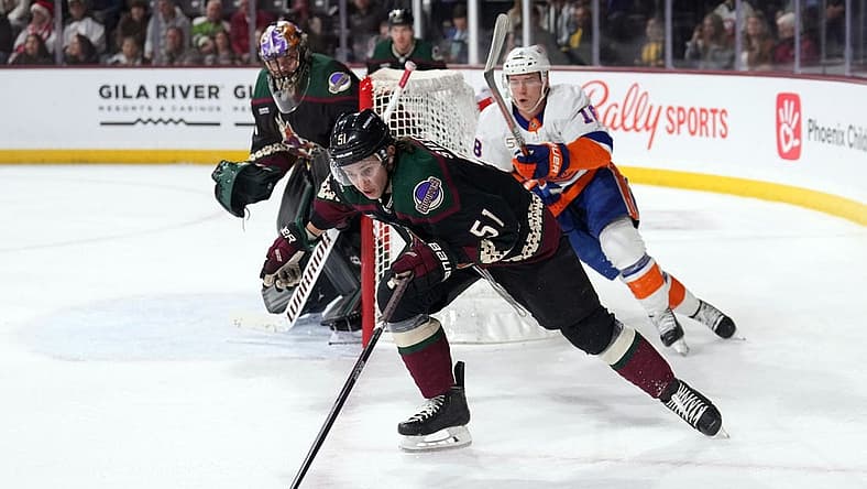 Dec 16, 2022; Tempe, Arizona, USA; Arizona Coyotes defenseman Troy Stecher (51) skates by New York Islanders left wing Anthony Beauvillier (18) during the first period at Mullett Arena. Mandatory Credit: Joe Camporeale-USA TODAY Sports
