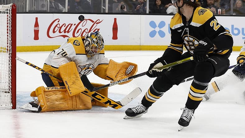 Mar 28, 2023; Boston, Massachusetts, USA; Boston Bruins defenseman Brandon Carlo (25) watches as his shot goes over the head of Nashville Predators goaltender Juuse Saros (74) during the first period at TD Garden. Mandatory Credit: Winslow Townson-USA TODAY Sports