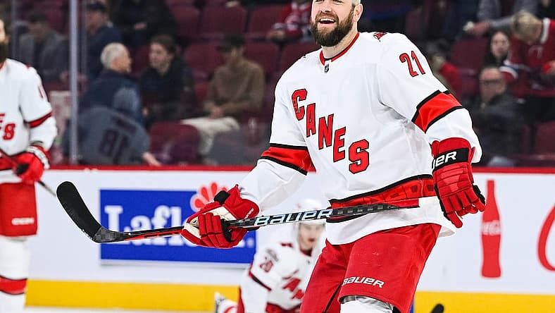 Apr 1, 2023; Montreal, Quebec, CAN; Carolina Hurricanes center Derek Stepan (21) smiles while looking at his teammates during warm-up before the game against the Montreal Canadiens at Bell Centre. Mandatory Credit: David Kirouac-USA TODAY Sports
