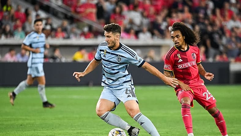 Sep 30, 2023; St. Louis, Missouri, USA; Sporting Kansas City midfielder Nemanja Radoja (6) shields the ball from St. Louis City midfielder Aziel Jackson (25) during the second half at CITYPARK. Mandatory Credit: Joe Puetz-USA TODAY Sports