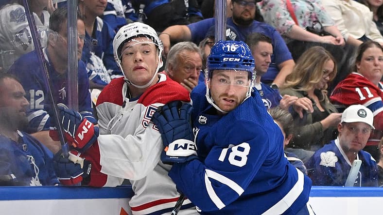 Oct 2, 2023; Toronto, Ontario, CAN; Toronto Maple Leafs forward Noah Gregor (18) bodychecks Montreal Canadiens defenseman Jordan Harris (54) the third period at Scotiabank Arena. Mandatory Credit: Dan Hamilton-USA TODAY Sports